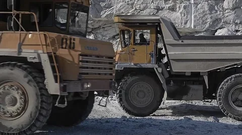 Excavator loads ore into dump-trucks. Stock Footage 63545738