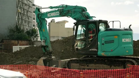 Excavator loads removed road material into a truck Stock Footage 324918484