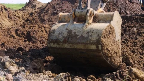 The excavator loads the soil into the bucket. Stock Footage 201855377