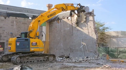 Excavator machine breaking down wall for building demolition A Stock Footage 114925662