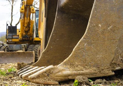 Excavator machine with a bucket in front Stock Photos