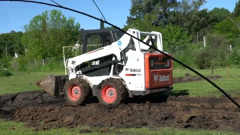 Excavator machine moving dirt - bobcat  Slow motion Stock Footage 142959062
