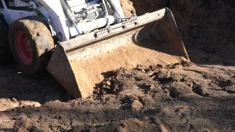 Excavator machine moving dirt - bobcat  Slow motion Stock Footage 142962467