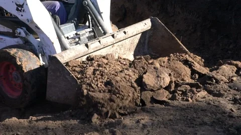 Excavator machine moving dirt - bobcat  Slow motion - pool - piscina Stock Footage