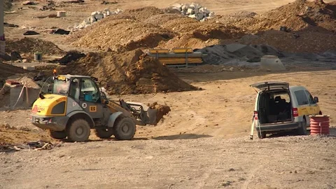 Excavator Machine Unloading Ground on a Construction Site Stock Footage 150499990