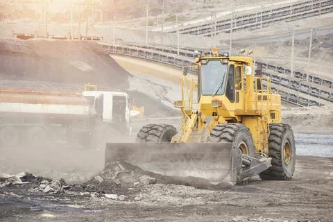 Excavator machine unloading sand with water,Mining Operations Stock Photos