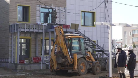 Excavator moves bucket digging soil on construction site Видео 306418266