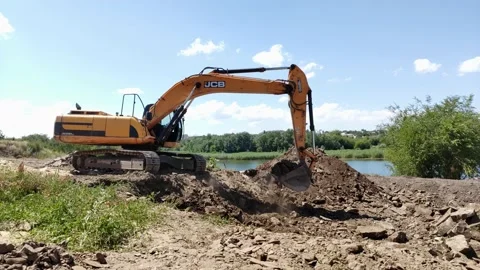 The excavator moves the soil on the construction site, earthworks, digging a pit Stock Footage 217542543