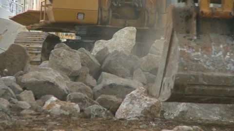 Excavator moving large rocks Stock Footage 10812449