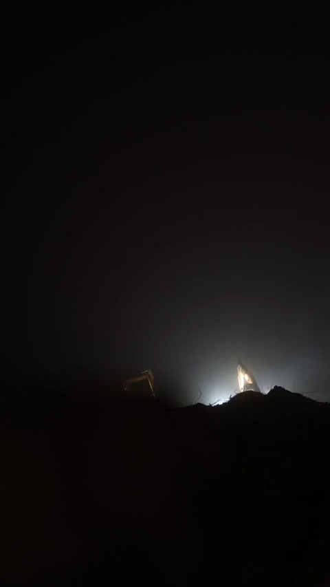 Excavator operates in complete darkness with one light at construction site Stock Footage 296543704