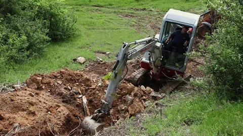 Excavator operating and digging soil for new electricity line. Video stock 81418372
