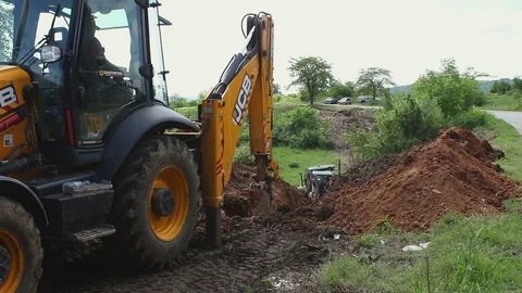 Excavator operating and digging soil for new electricity line. Stock Footage 81469007