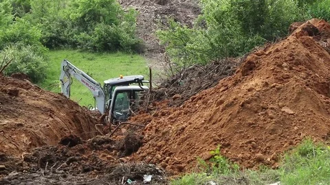Excavator operating and digging soil for new electricity line. Video stock 81469069