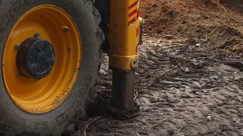 Excavator operating and digging soil for new electricity line. 库存影片 81469128