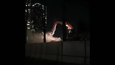 Excavator operation in the dark. The vertical video was shot on a mobile phone. Stock Footage 164918648