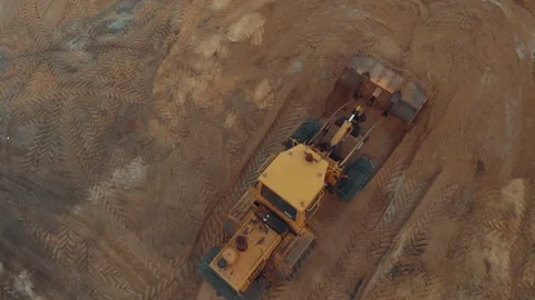 Excavator or bulldozer working on construction site with sand aerial top view Stock Footage 152106922