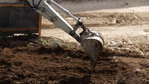 An excavator is performing excavation work at a construction site. Stock Footage 318191793