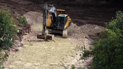 An excavator is performing excavation work at a construction site. Stock-Footage 318192243