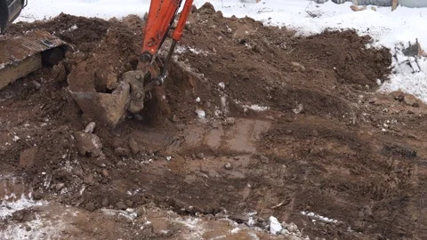 An excavator is performing excavation work at a construction site.  Stock-Footage 327693126