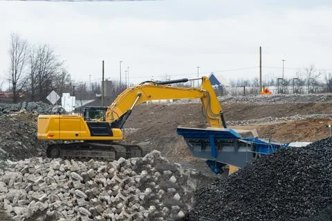 Excavator performs excavation work Stock Photos