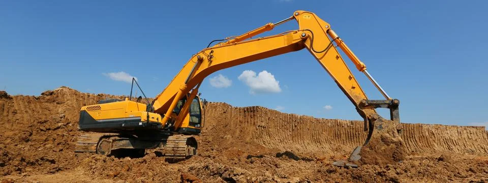 The excavator performs work at the quarry. Stock Photos