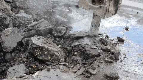 Excavator with Pneumatic drill breaking and drilling concrete on the road Stock Footage 111888151