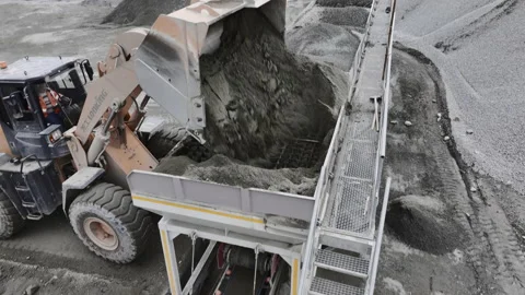 Excavator pours soil into sorting machine at rock quarry Stock Footage 237026942