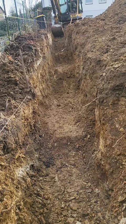 Excavator Power: A Construction Worker Operates a Heavy Machine on a Job Site Stock Footage 269788334