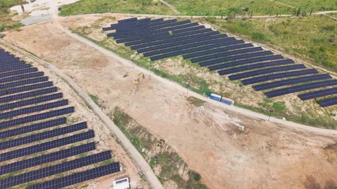 Excavator Preparing Ground Beside Completed Solar Farm in Attica Greece Stock Footage 338049420