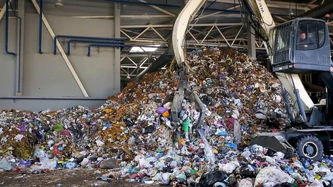 Excavator on primary sorting of garbage at waste processing plant. Stock Footage 96772516