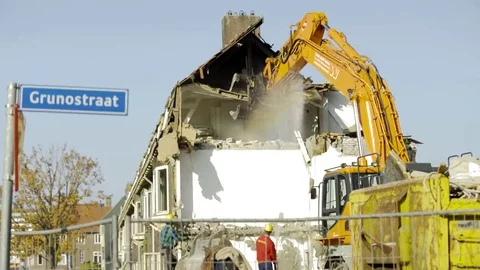 Excavator pulls down attic - 4K Stock Footage 69180020