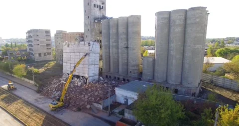Excavator pushes concrete elevator building for destroy Stock Footage 141440640
