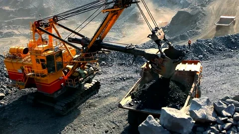 An excavator in a quarry loads soil into a dump truck. The process of mining Видео 165392574