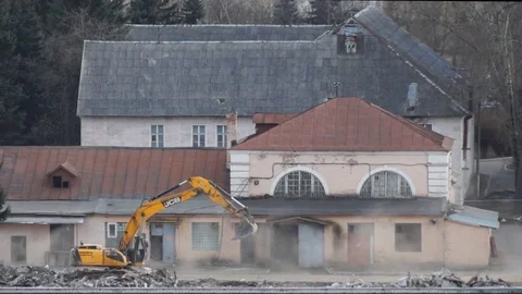 Excavator removes construction debris on spring day Stock Footage 82370709