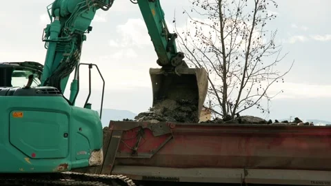 Excavator removes old asphalt using a bucket Stock Footage 324918444