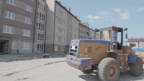Excavator rides on a construction site Stock Footage 132490913