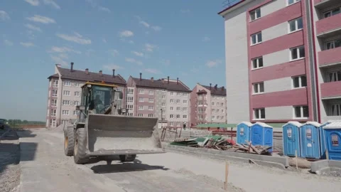 Excavator rides on a construction site Stock Footage 132490950