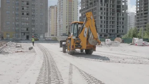 Excavator rides on a construction site Stock Footage 132493882