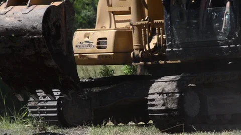Excavator rolling forward on tracks Stock Footage
