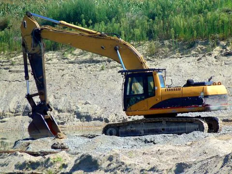 An excavator on the sand Fotos Stock