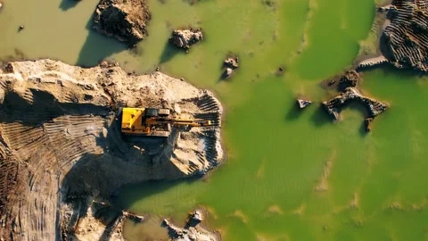 Excavator scooping and unloading soil onto a waiting large truck - Top down Stock Footage 191921945