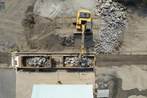 Excavator scooping rocks, stone construction Stock Illustration