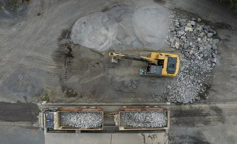 Excavator scooping rocks, stone construction Stock Illustration