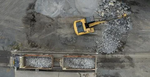 Excavator scooping rocks, stone construction Stock Photos