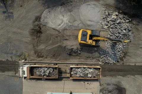 Excavator scooping rocks, stone construction Stock Photos
