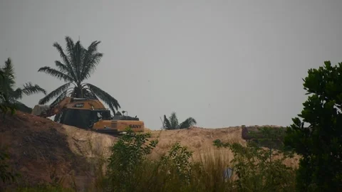 An excavator is scooping soil Stock Footage 253421223