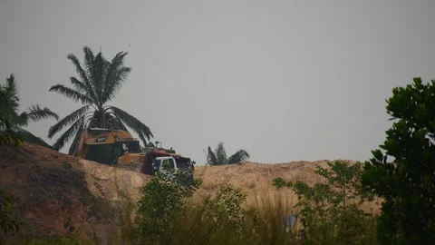 An excavator is scooping up the soil Stock Footage 253421229