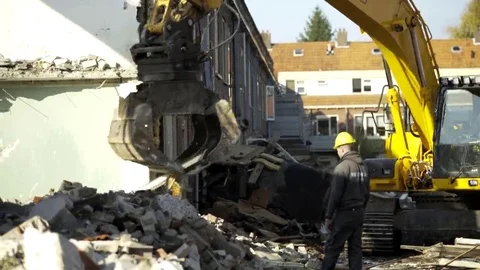 Excavator segregates debris - 4K Stock Footage 69166436