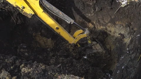 Excavator shovel digs into a ground Stock Footage 94458567
