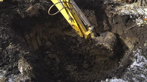Excavator shovel digs into a ground Stock Footage 94459224